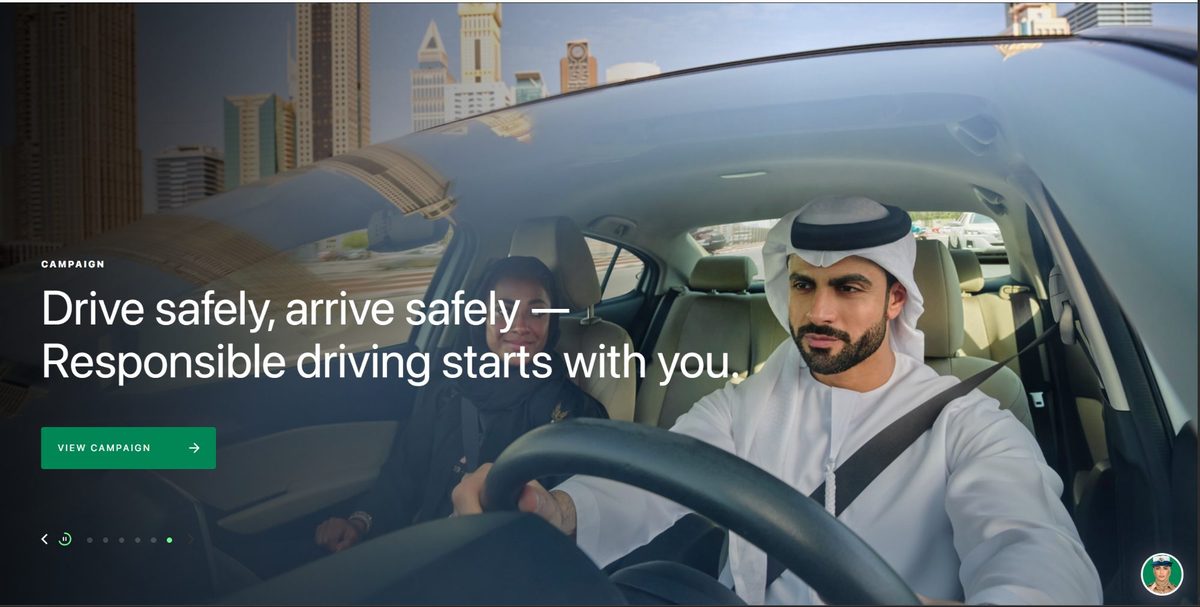 Production still from the Aman Roads hero film showing an Emirati man distracted by his mobile phone while driving